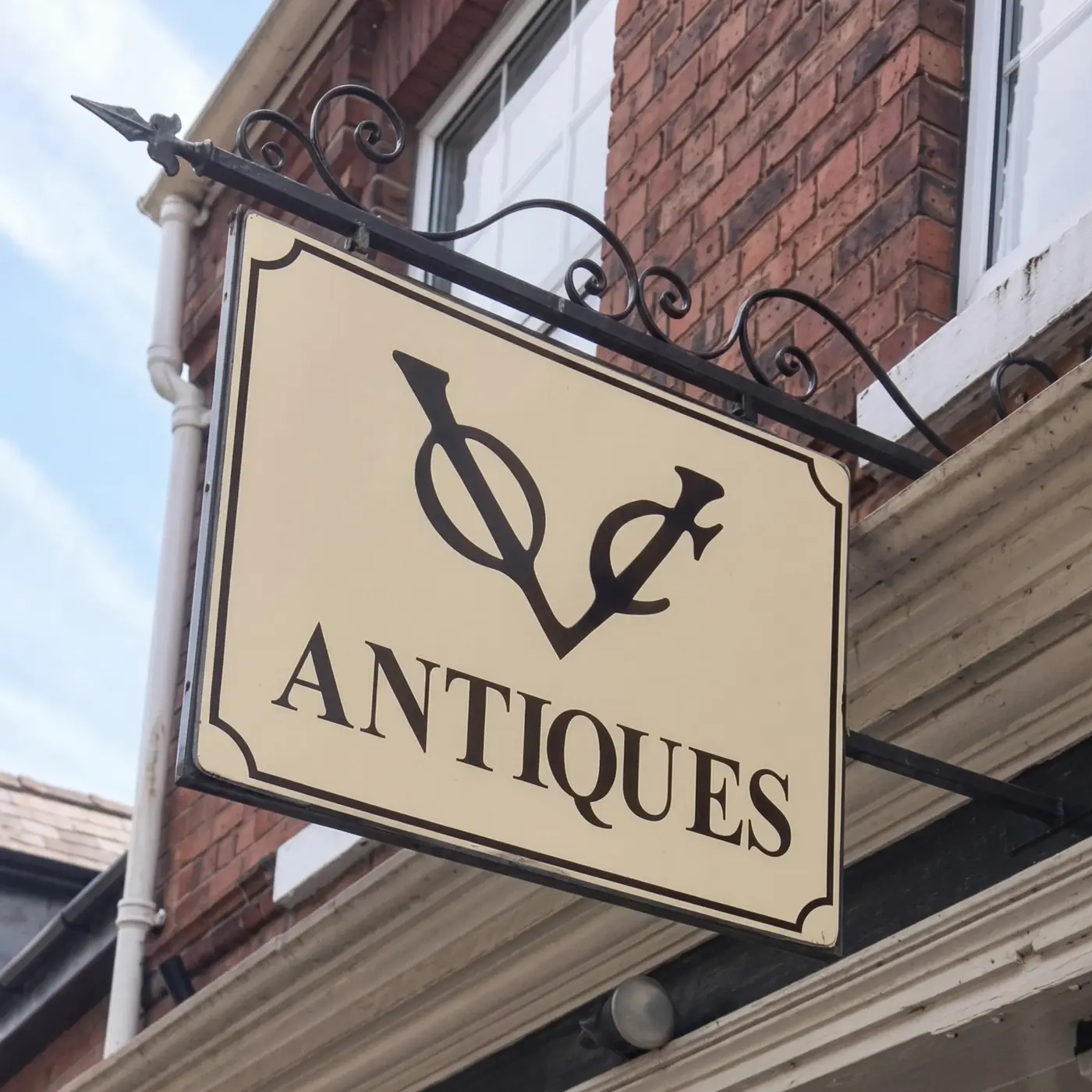 The VOC Antiques hanging sign on Witham Road